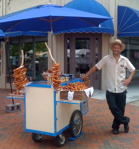 Eddy standing by a pretzel cart in downtown Asheville